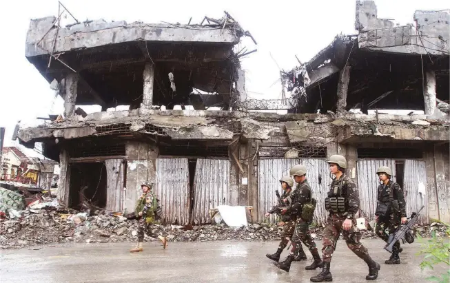  ??  ?? REBUILDING A RAVAGED CITY – As government forces clear the last terrorist stronghold­s in Marawi City, attention shifts to the massive task of rebuilding the war-ravaged capital of Lanao del Sur. The government said it will release 15 billion for...