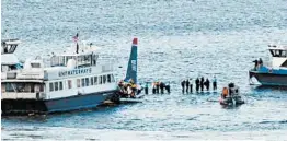  ?? BEBETO MATTHEWS/AP ?? Passengers stand on the wing of a US Airways jetliner waiting to be rescued by ferry boats that rushed to the plane in New York’s Hudson River on Jan. 15, 2009.