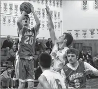  ?? T.J. COLELLO/CAPE BRETON POST ?? Jason Callaghan of the Sydney Academy Wildcats (20) takes a jumper while being challenged by Ethan Merlin of the Riverview Royals (8), while Coby Tunnicliff or the Royals (6) and Jarret Williams of the Wildcats (6) jockey for position. Callaghan scored...