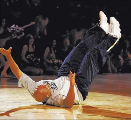  ?? REVIEW-JOURNAL FILE PHOTO ?? NBA legend Charles Barkley falls to the court after racing backward in a charity race against 67-year-old referee Dick Bavetta during NBA All-Star Weekend festivitie­s on Feb. 17, 2007, at the Thomas & Mack Center. Barkley fell across the finish line...