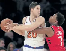  ?? JULIE JACOBSON/THE ASSOCIATED PRESS ?? New York Knicks forward Doug McDermott plays keep away from Toronto Raptors guard Kyle Lowry on Wednesday in New York. The Knicks defeated the Raptors 108-100 on the back of a terrible Raptors third quarter.