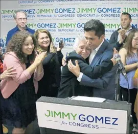  ?? Robert Gauthier Los Angeles Times ?? JIMMY GOMEZ hugs his mother, Socorro Gomez Martinez, at his election night rally. The stoic 73-year-old was overjoyed by his congressio­nal run, Gomez said.