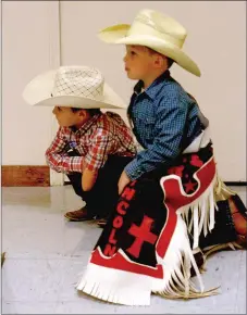  ?? MARK HUMPHREY ENTERPRISE-LEADER ?? Planning their next move. Junior cowboys Colton Workman (left) and Gavin Hammack ponder what to do next while watching the Little Miss and Little Mister Lincoln Riding Club 2014 contest. Workman is a candidate for Little Mister again this year.