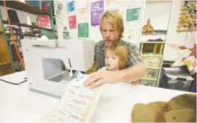  ??  ?? Taylor McDonald and son, Knox, 5, work together during the Sew What class at the Chattanoog­a Public Library.