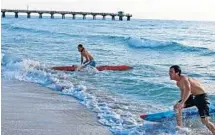  ?? PHOTOS BY EMMETT HALL ?? Left, South Florida lifeguards competed in the 16th annual 2-Mile Paddleboar­d Series in Pompano Beach. From left are Fort Lauderdale Ocean Rescue’s Blake Kammener, Palm Beach County’s Kevin Jones and Deerfield Beach Ocean Rescue’s Konnor Katzmark....