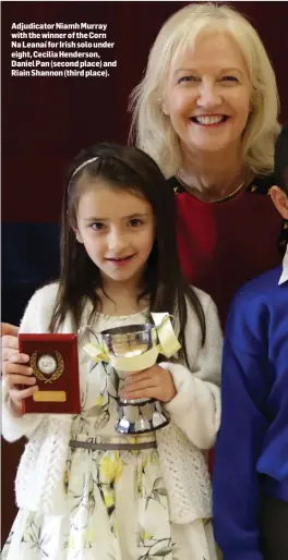  ??  ?? Adjudicato­r Niamh Murray with the winner of the Corn Na Leanaí for Irish solo under eight, Cecilia Henderson, Daniel Pan (second place) and Riain Shannon (third place).