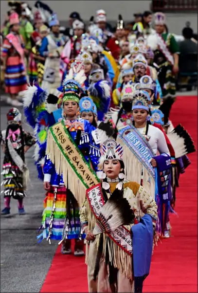  ?? HELEN H. RICHARDSON — THE DENVER POST ?? Pow Wow Princess Tessa Holds The Enemy Abbey leads other royalty and members into the arena during the grand entry of the Denver March Powwow on Sunday at the Denver Coliseum.