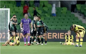  ?? GETTY IMAGES ?? Wellington Phoenix players slump to the turf at AAMI Park following their eliminatio­n final defeat to Western United.