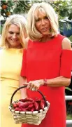  ?? — AFP photo ?? Brigitte (right) holds a basket full of Espelette peppers during a visit with spouses of the leader of G7, on traditiona­l Basque culture in Espelette, near Biarritz as part of the G7 summit.