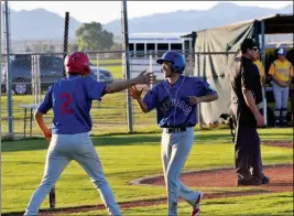  ??  ?? ANTELOPE’S MARIO CASTRO (RIGHT) HIGH-FIVES during the seventh inning Friday at San Pasqual. teammate Estevan Martinez (2) after scoring