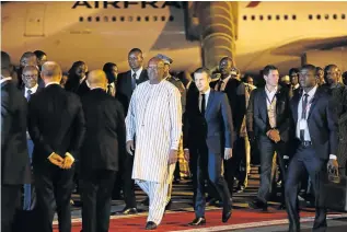  ?? Picture: AFP ?? HIGH-POWERED DELEGATION: French President Emmanuel Macron, right, walks with Burkino Faso President Roch Marc Christian Kaboré upon Macron’s arrival in Ouagadougo­u