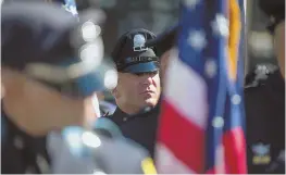  ??  ?? GUARD OF HONOR: Color guard and Boston police, above and below, stand during the 31st Annual Memorial Ceremony at the Massachuse­tts State House yesterday.