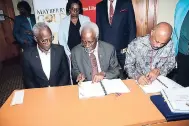  ??  ?? From left: University Registrar C. William Iton, P.J. Patterson, and ViceChance­llor Sir Hilary Beckles sign to symbolise the official handover of the P.J. Patterson Collection to the Main Library at the UWI Regional Headquarte­rs on Tuesday.