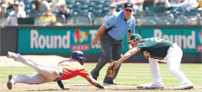  ??  ?? OAKLAND: Matt Olson #28 of the Oakland Athletics tags out baserunner Marwin Gonzalez #9 of the Houston Astros at first base in the second inning at Oakland Alameda Coliseum on Sunday in Oakland, California. — AFP