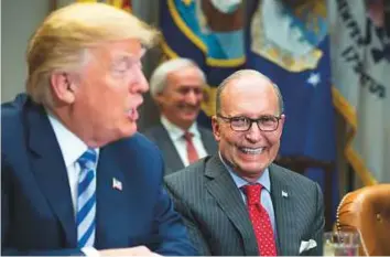  ?? Bloomberg ?? Larry Kudlow (right), reacts while US President Donald Trump speaks during a meeting with automotive executives in the White House in Washington.