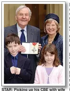  ??  ?? STAR: Picking up his CBE with wife Annie and grandchild­ren in 2003