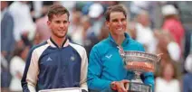  ??  ?? Rafael Nadal, right, and Dominic Thiem pose with their trophies.