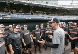  ?? NATI HARNIK — THE ASSOCIATED PRESS ?? Oregon State coach Pat Casey addresses his players in the dugout before team practice in Omaha, Neb. Friday. Oregon State is on the cusp of joining the company of the greatest college baseball teams of all time. At 54-4, the Beavers enter the College...