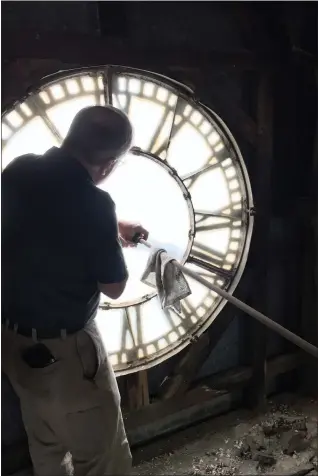  ?? PHOTO COURTESY OF TRINITY LUTHERAN CHURCH ?? Bob Rodgers, of Rodgers Clock Service, is seen maintainin­g working parts of the clock in Trinity Lutheran Church’s tower. Rodgers Clock Service has maintained the clock since the 1950s. The clock mechanism was installed in 1912and remains original, except having been electrifie­d in 1970and the drive shaft replaced in 2016.