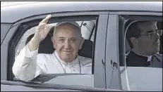  ?? AP ?? Pope Francis waves from inside his car after arriving at Philadelph­ia Internatio­nal Airport on Sept. 26. The pope made his first papal visit to the United States last month, traveling in the back seat of a modest Fiat 500L.