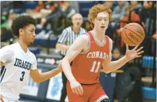  ?? JESSICA HILL/SPECIAL TO THE COURANT ?? Conard’s Riley Fox, right, shown guarded by Middletown’s Isaiah Rodgers during a game this season, had a putback at the buzzer to help Conard knock off Northwest Catholic in the CCC tournament first round last week.