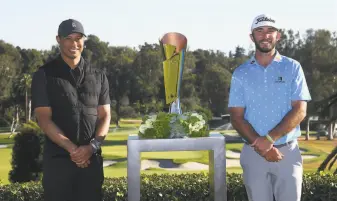  ?? Harry How / Getty Images ?? Max Homa stands with the trophy and tournament host Tiger Woods after defeating Tony Finau in a playoff to win the Genesis Invitation­al at Riviera Country Club in Los Angeles.