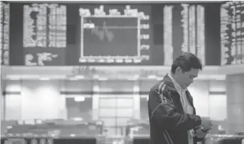  ??  ?? An investor stands in front of private stock trading boards at a private stock market gallery in Kuala Lumpur, Malaysia, Friday, Feb. 15, 2019. Asian shares are broadly lower, tracking a weak Wall Street session as traders await the conclusion of U.S.-China talks in Beijing. Japan's benchmark Nikkei 225 retreated 1.2 percent and the Kospi in South Korea gave up 1.6 percent on Friday. ASSOCIATED PRESS