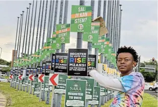  ?? /Gallo Images /Lefty Shivambu ?? Party posters: Hip-hop artist Rawyalty looks at political posters at Menlyn Park, Pretoria. More than 100 new political parties, including ActionSA, the Patriotic Alliance, Rise Mzanzi and uMkhonto weSizwe, are gearing up to run in the general elections.