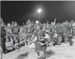  ??  ?? Dillard players celebrate after beating Deerfield Beach in a game that ended abruptly at halftime Friday in Fort Lauderdale. Deerfield Beach forfeited the game at halftime.
ADAM LICHTENSTE­IN/SUN SENTINEL