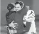  ?? MICKEY WELSH/THE MONTGOMERY ADVERTISER VIA AP ?? Memphis quarterbac­k Brady White holds his MVP trophy as he hugs his head coach, Ryan Silverfiel­d, on Wednesday.