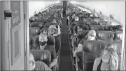  ?? Christophe­r Reynolds/los Angeles Times/tns ?? Masked passengers fill a Southwest Airlines flight from Burbank, Calif., to Las Vegas with the middle seats left open.