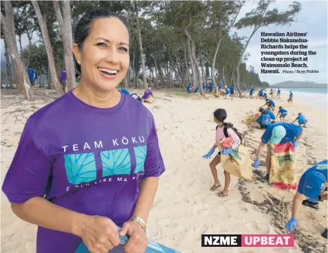  ?? Photo / Brett Phibbs ?? Hawaiian Airlines’ Debbie NakaneluaR­ichards helps the youngsters during the clean-up project at Waimanalo Beach, Hawaii.