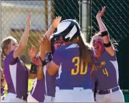  ??  ?? Emma Hansen is mobbed by her Middletown teammates, including Alli Huston (4), following her home run.