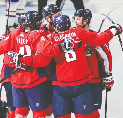  ?? GEOFF BURKE/USA TODAY SPORTS ?? Alex Ovechkin celebrates with teammates after scoring goal No. 699 against the Montreal Canadiens on Thursday.