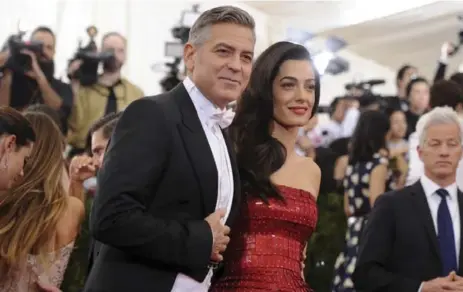  ?? EVAN AGOSTINI/THE ASSOCIATED PRESS FILE PHOTO ?? Actor George Clooney and his wife, Amal, in 2015, before the arrival of their twins, when Clooney was still the patron saint for the childless.