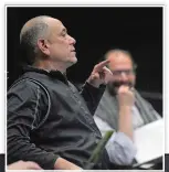  ??  ?? Above, Artistic director/choreograp­her David Dorfman, left, directs cast members as Connecticu­t College theater director David Jaffe, right, looks on during a rehearsal of “Carousel” at the Tansill Theater on Feb. 17.