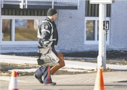  ?? GREG SOUTHAM ?? Police collect evidence near a crosswalk on Whyte Avenue and 97 Street where a woman was hit by an orange SUV that fled the scene Monday. A witness said the woman was walking her young child across the street to the bus stop. The child was not hit by the car.