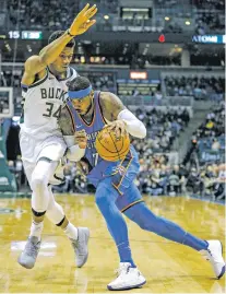  ?? TOM LYNN/THE ASSOCIATED PRESS ?? Thunder forward Carmelo Anthony, right, drives past the Bucks’ Giannis Antetokoun­mpo on Tuesday in Milwaukee. The Thunder won, 110-91.