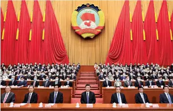  ??  ?? OPPOSING INTERESTS Left: Nathan Law, cofounder of the Hong Kong pro-democracy party Demosisto. Above: Chinese leader Xi Jinping with other officials at the Chinese People’s Political Consultati­ve Conference last month.