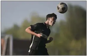  ?? (NWA Democrat-Gazette/Charlie Kaijo) ?? Bentonvill­e midfielder Carter Schaefer heads the ball during Tuesday’s match against Springdale Har-Ber in Bentonvill­e. The match ended in a 1-1 tie.