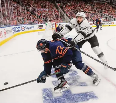  ?? Jason Franson / Associated Press ?? Tyson Barrie (22) and the Edmonton Oilers took buses into Washington state as part of their travel to Los Angeles, while Phillip Danault and the Kings flew directly to Canada.