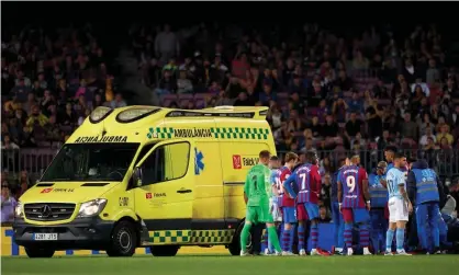  ?? ?? Barcelona’s Ronald Araújo is treated by doctors on the Camp Nou pitch before being taken away by ambulance. Photograph: Quality Sport Images/Getty Images