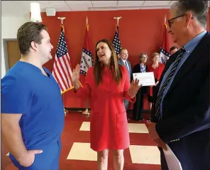  ?? (Arkansas Democrat-Gazette/Thomas Metthe) ?? Gov. Sarah Huckabee Sanders (center) talks with John Brown University nursing graduate Tanner Meyer (left) and Jim Krall (right), Vice President of advancemen­t at John Brown, after the Arkansas Department of Commerce gave away grant money to the state’s nursing schools on Monday, May 13, 2024, in Little Rock.