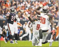  ?? Nam Y. Huh / Associated Press ?? The Buccaneers’ Jason Pierre-Paul, right, celebrates a sack against the Bears earlier this season.