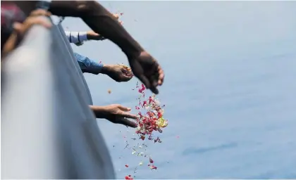  ?? Photos / AP ?? The Lion Air flight crashed into the waters off Java a month ago. Relatives, above, sprinkle flowers for the victims. “Our job isn’t to find faults,” safety committee investigat­or Nurcahyo Utomo, below, said.