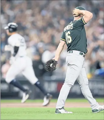  ?? JANE TYSKA – STAFF PHOTOGRAPH­ER ?? A’s starting pitcher Liam Hendriks, right, reacts after giving up a two-run home run to the New York Yankees’ Aaron Judge in the first inning of Wednesday’s American League wild-card game at Yankee Stadium.