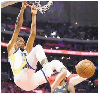  ?? GETTY ?? Kevin Durant hangs from the rim during the Warriors’ Game 4 win against the Clippers in LA. The champs will look to end their Pacific Division rivals’ season in Game 5.