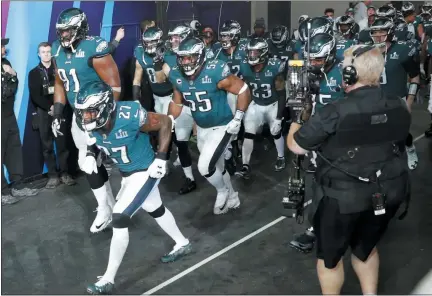  ?? CHARLIE NEIBERGALL — THE ASSOCIATED PRESS FILE ?? Philadelph­ia Eagles players run to the field as they are introduced before Super Bowl 52, Sunday, Feb. 4, 2018, in Minneapoli­s. The Eagles return to Minneapoli­s for the first time since their Super Bowl win when they face the Vikings on Sunday.