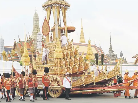  ??  ?? The Royal Urn is carried in the Royal Chariot during the funeral procession for the late Bhumibol in Bangkok. — AFP photo