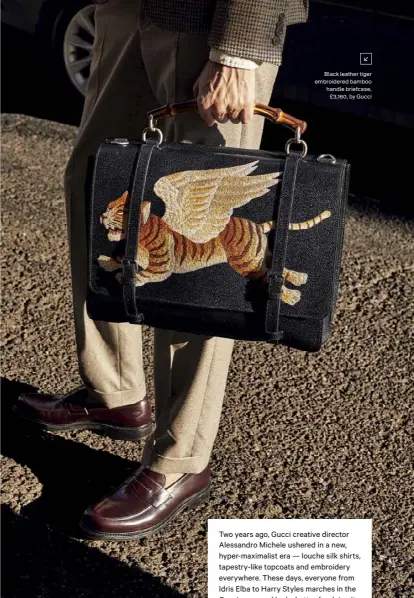  ??  ?? Black leather tiger embroidere­d bamboo handle briefcase,
£3,160, by Gucci